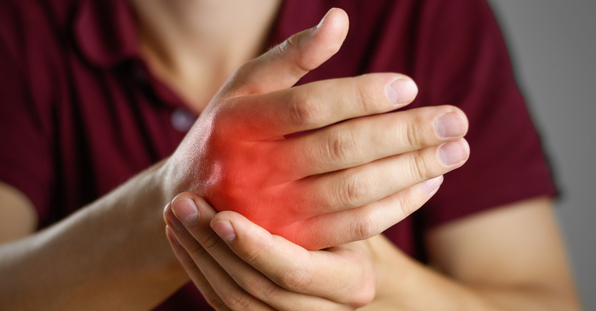 A person suffering from pain in inflamed knuckles.