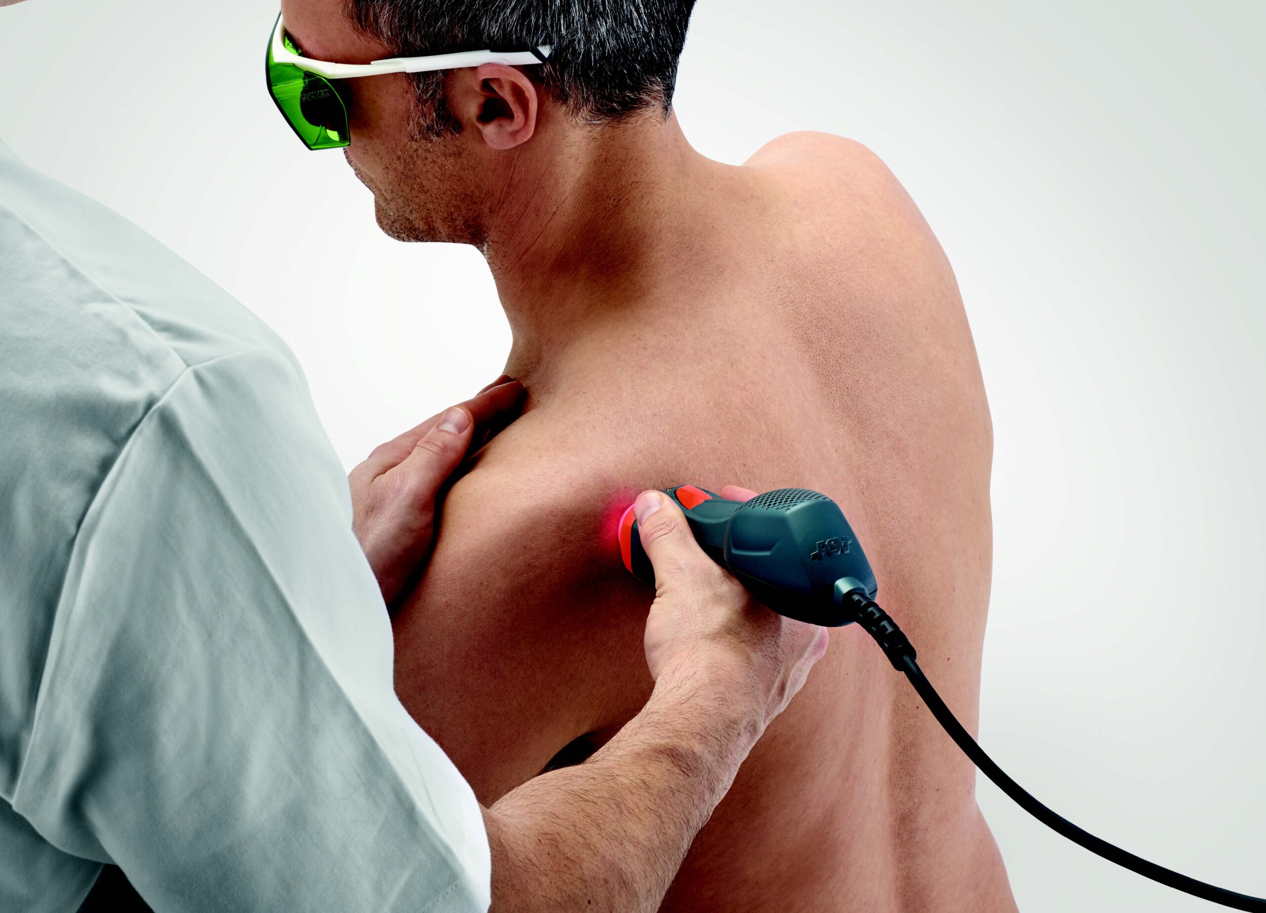 A man receiving MLS® laser therapy on his shoulder.