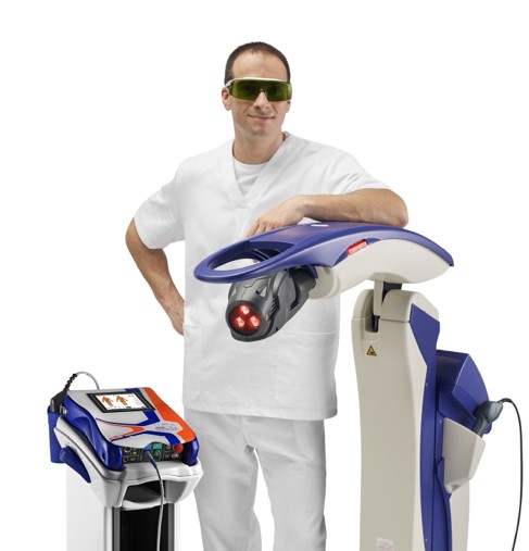 A man standing proudly with two MLS® laser therapy devices.