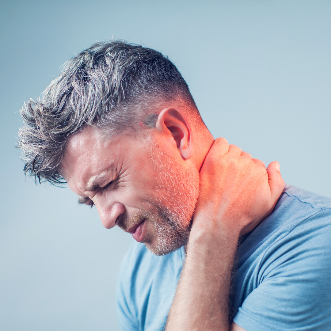 A man holding his neck in pain.