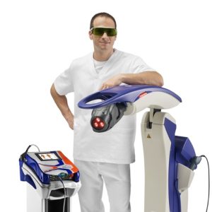 A man standing proudly with two MLS® laser therapy devices.